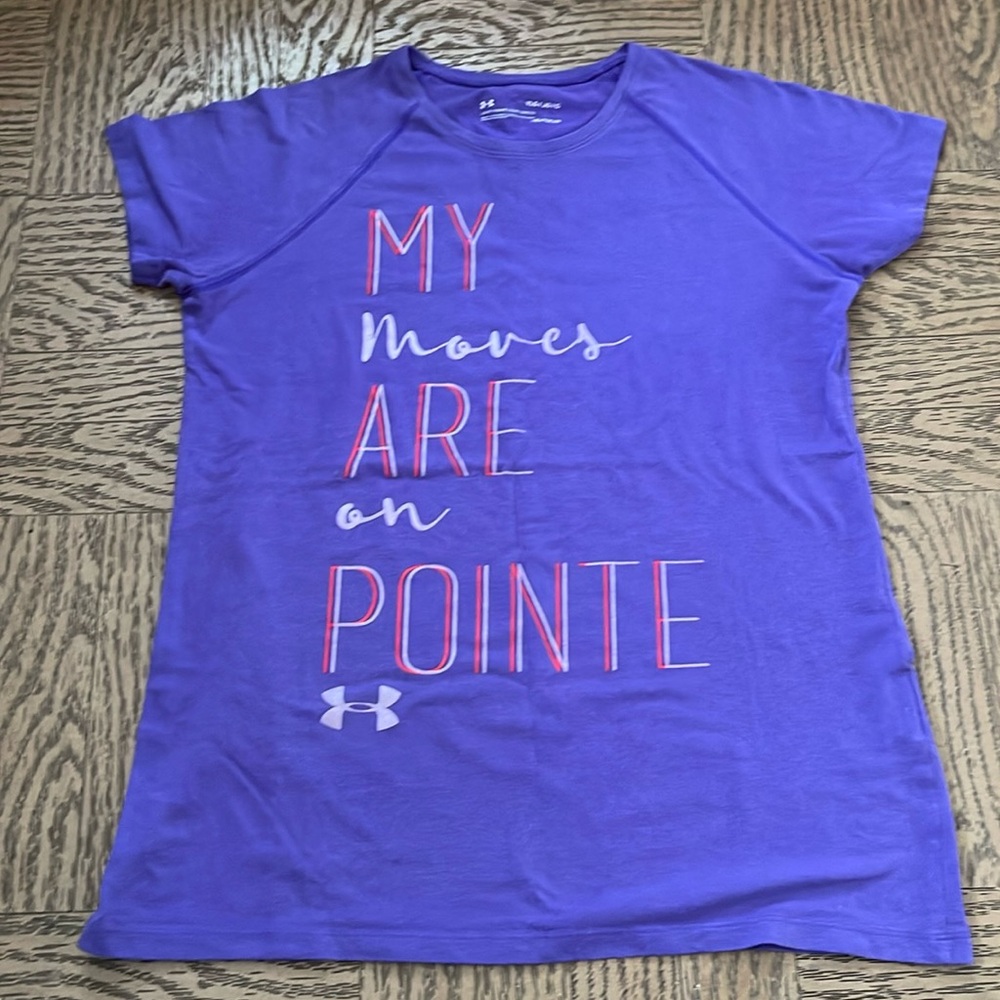 A purple under armour shirt that says “my moves are on pointe”